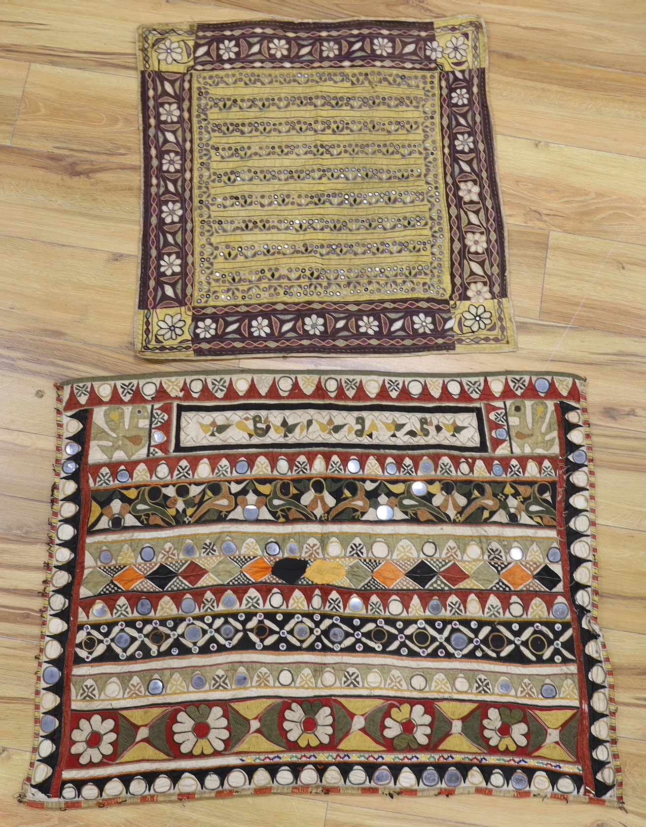 Two Indian embroidered and mirrored panels, possibly wall hangings, the largest 86cm x 67cm